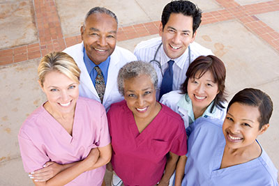 a group of doctors and nurses posing for the camera